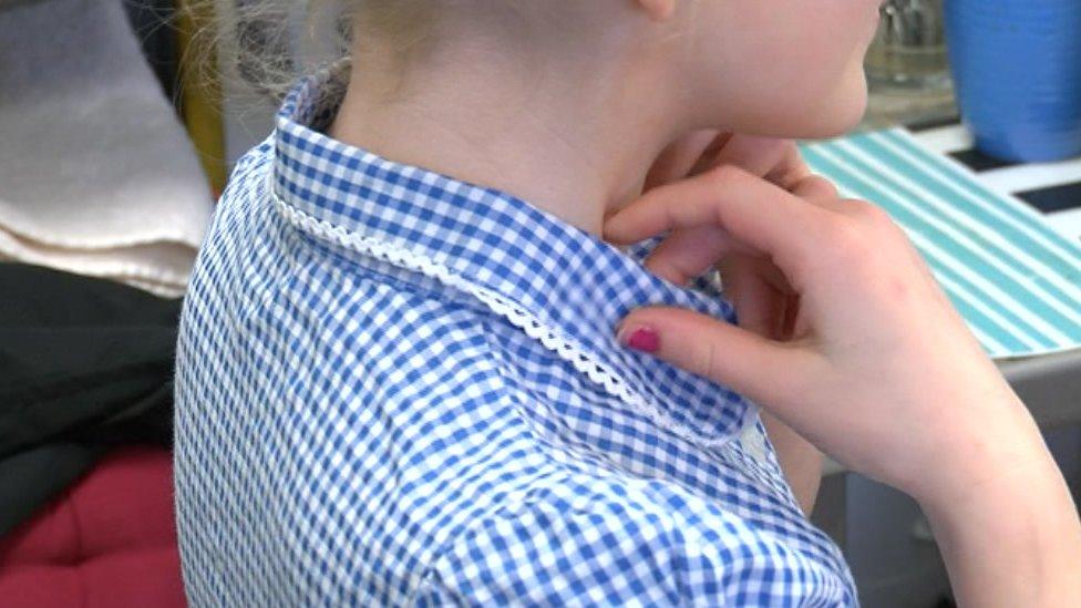 Girl trying on a school uniform