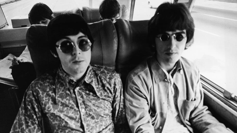 Paul McCartney and George Harrison onboard the tour bus