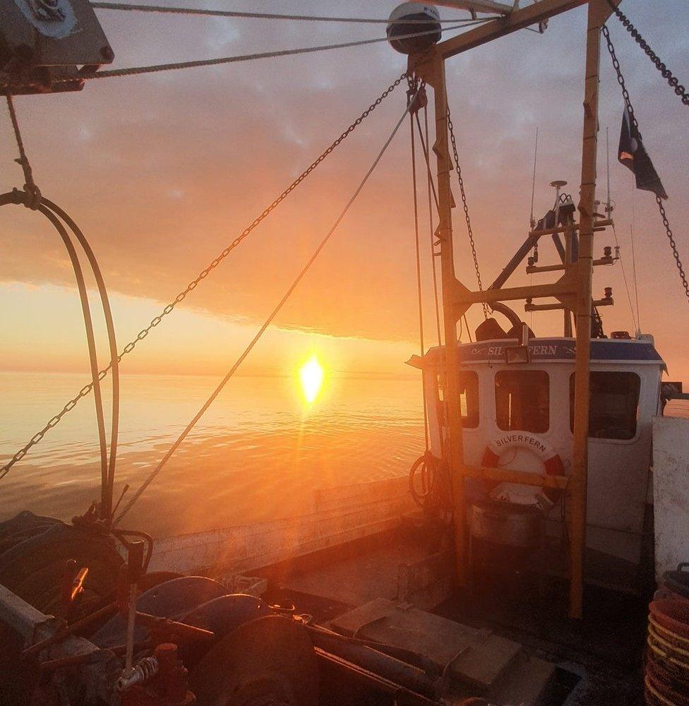 View of sunset on board at night