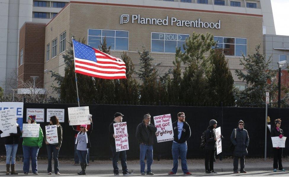 Pro-choice counter-protesters hold signs supporting a woman's right to choose abortion, as nearby anti-abortion activists held a rally in front of Planned Parenthood of the Rocky Mountains, in Denver, Saturday, Feb. 11, 2017.