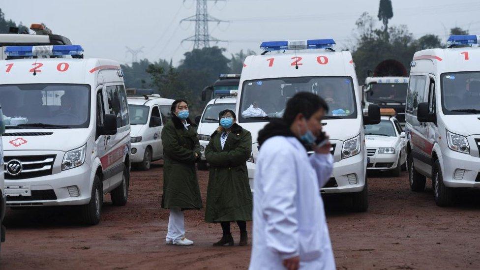 Rescue personnel wait beside parked ambulances outside the Diaoshuidong coal mine in south-western China's Chongqing on December 5, 2020,