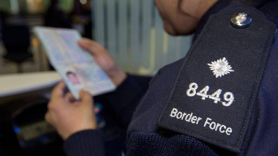 UK immigration officer checking passport