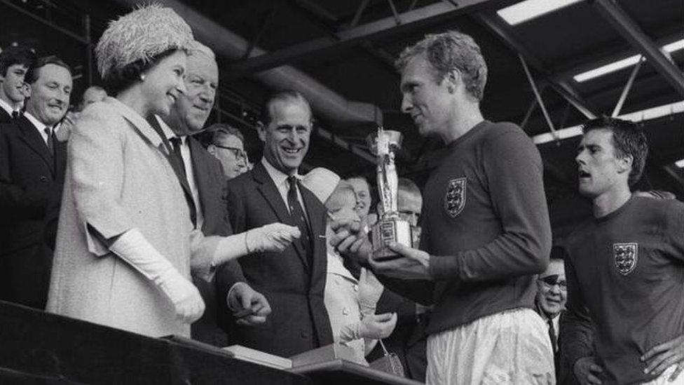 England captain Bobby Moore collecting the Jules Rimet Trophy after leading his team to a 4-2 victory over West Germany, in the World Cup Final at Wembley, London