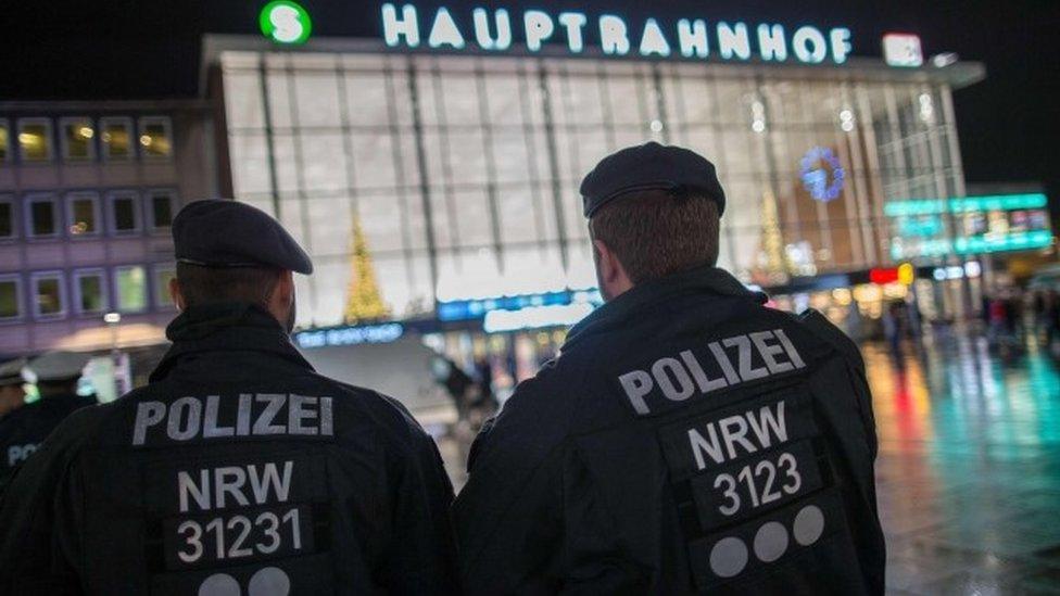 Police officers survey the area in front of the main train station and the Cathedral in Cologne, western Germany, 6 Jan