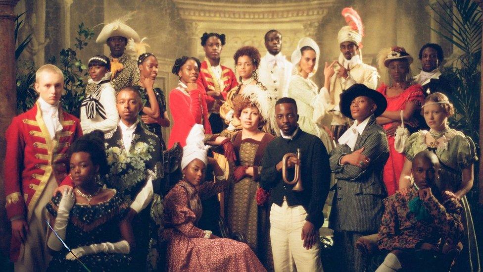 A group picture of the cast of Black to Life is costume