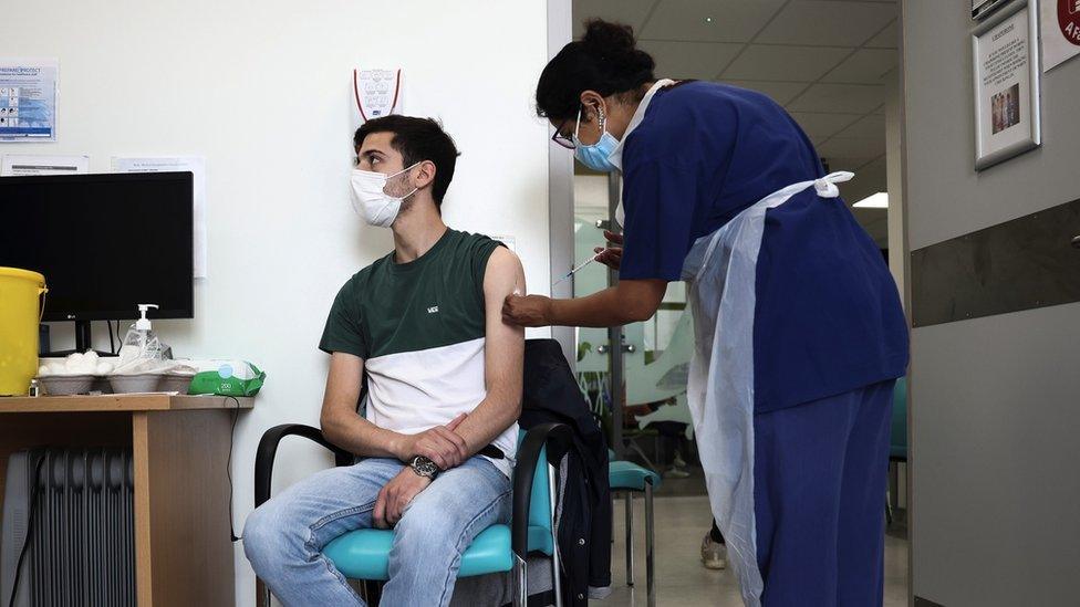 A young man receiving a vaccine