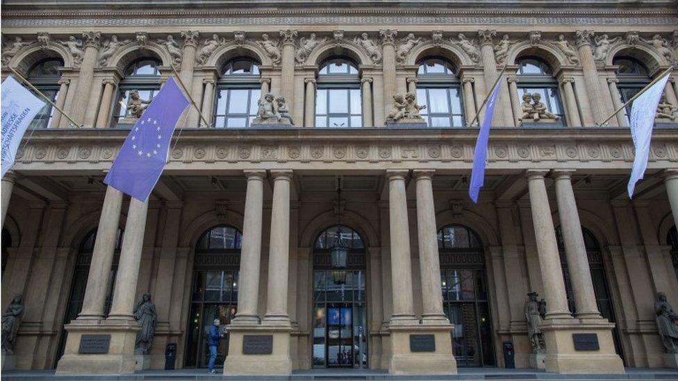 European flags hang above the entrance of the stock exchange in Frankfurt am Main, Germany