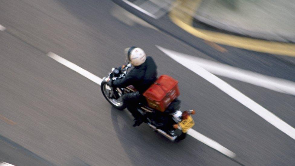 Food courier on motorcycle