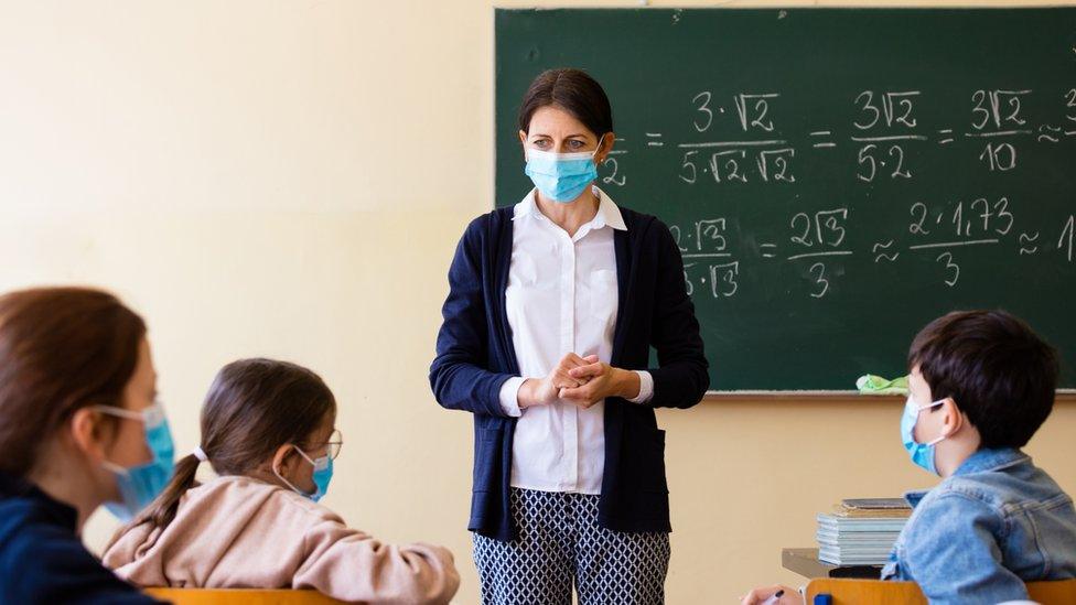 Teacher and pupils wearing masks