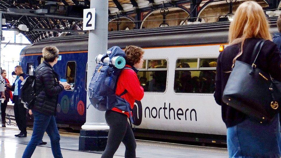 Commuters wait by northern train