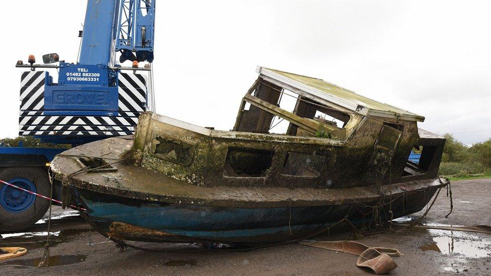 Abandoned boat grounded on the riverbank