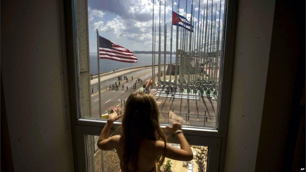 A child looks out a window from inside the newly opened US embassy overlooking the staging area on 14 August 2015