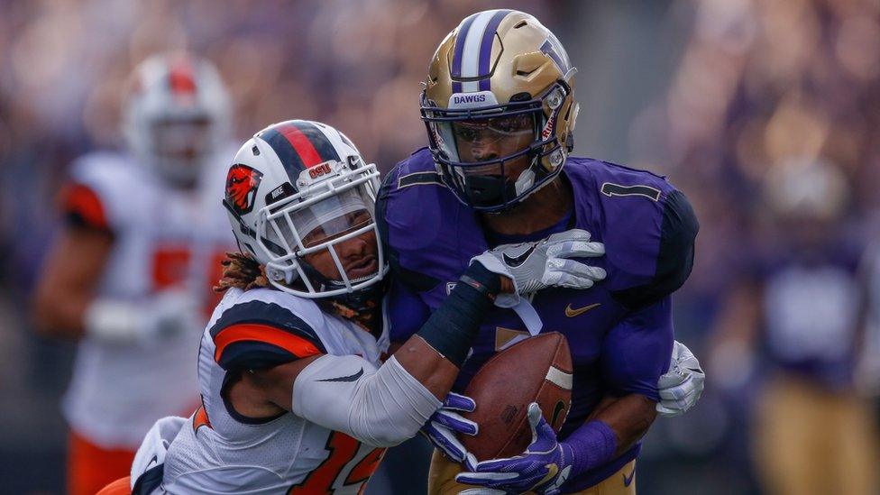 John Ross being tackled in a game for the University of Washington