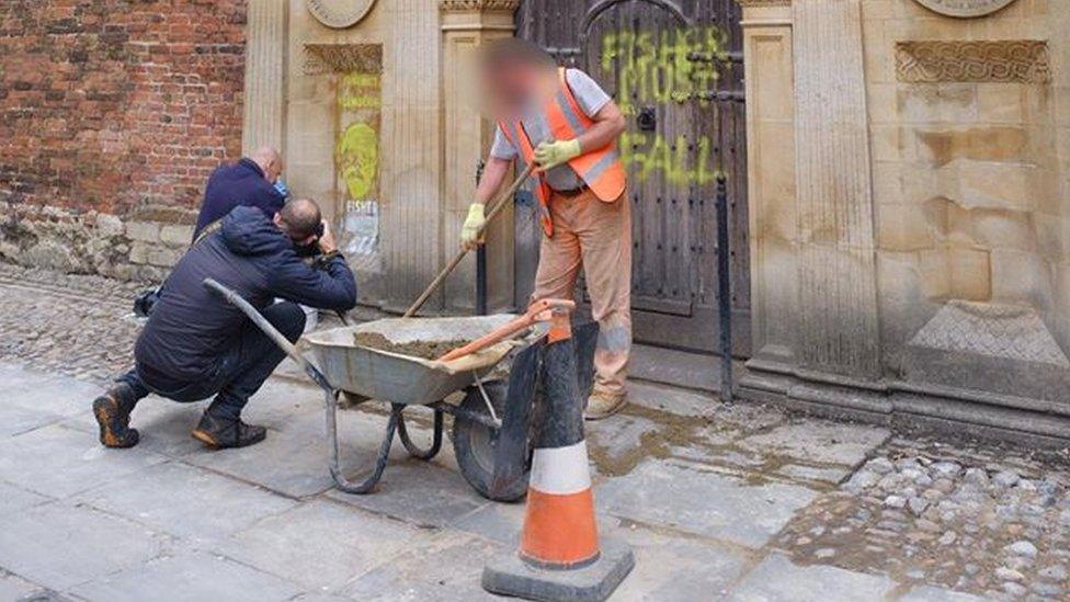 Work to clean the spray paint at the Gate of Honour