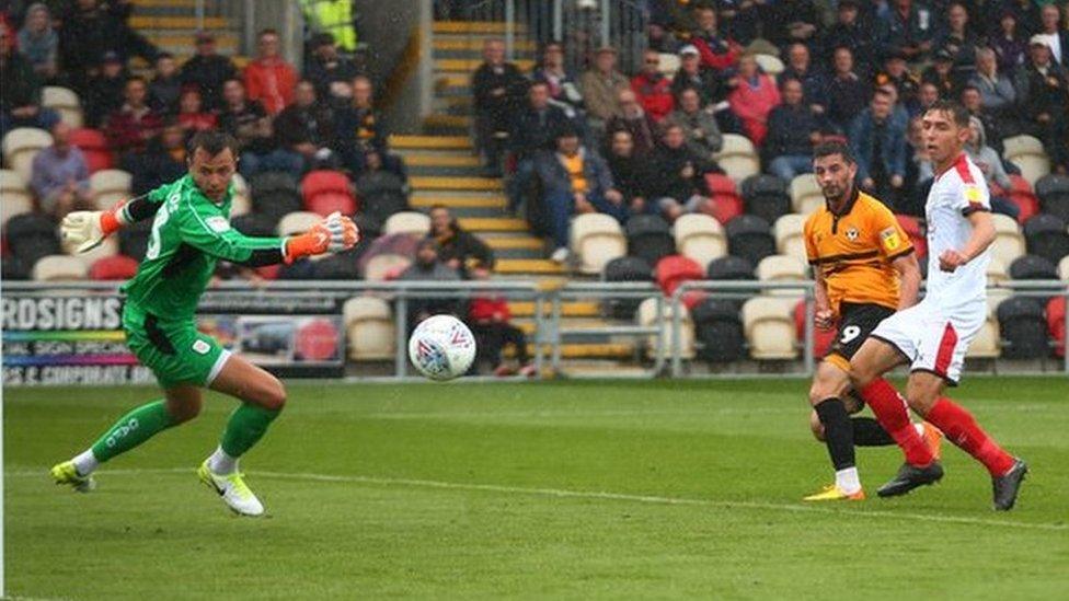 Padraig Amond puts the ball past Crewe keeper Dave Richards to give Newport the lead