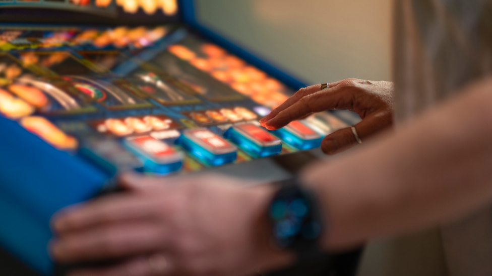 Anonymous image of a person playing a gaming machine