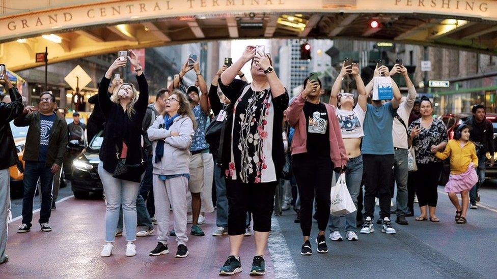 People taking photos at Manhattanhenge on 30 May