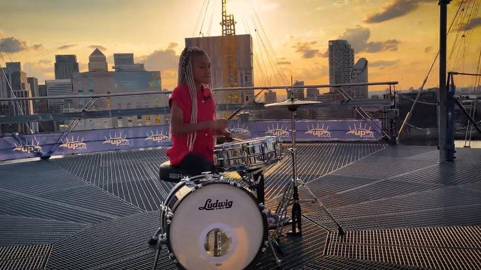 Nandi Bushell drumming on top of the O2 in London