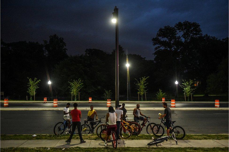 Young people ride their bikes on Reisterstown Rd. outside the parking lot of Hip Hop Chicken in Baltimore, Maryland, U.S., May 26, 2019. Each Sunday the bikers gather to ride their bikes and hang out in a loosely affiliated group of bikers