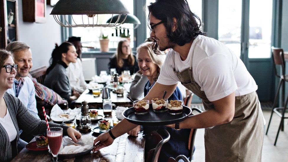 Waiter serving food