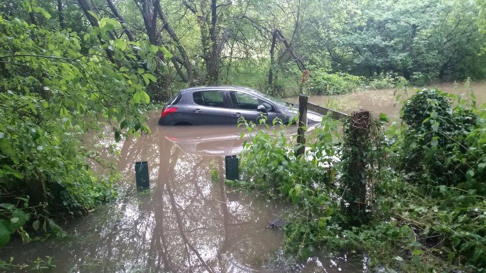 A car is trapped in a flooding at a lane in Southampton, UK