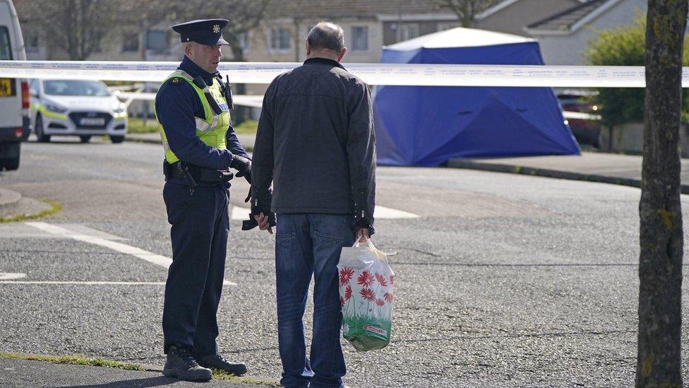 Garda officer and man at scene of shooting