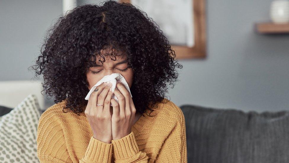 Woman blowing her nose