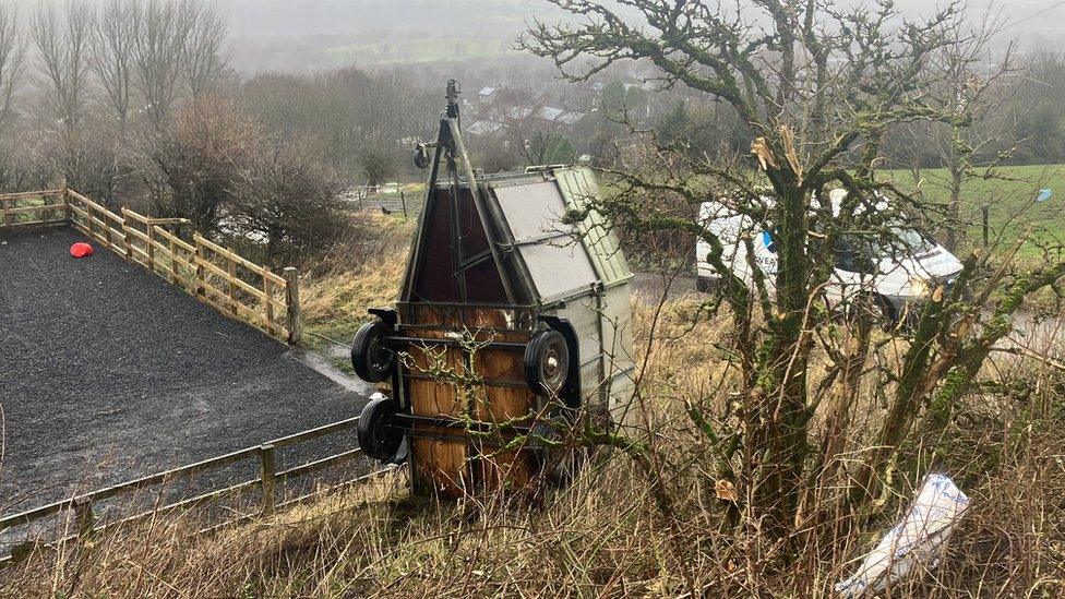 Horse box blown over by wind