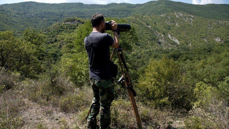 A police patrol surveys the border