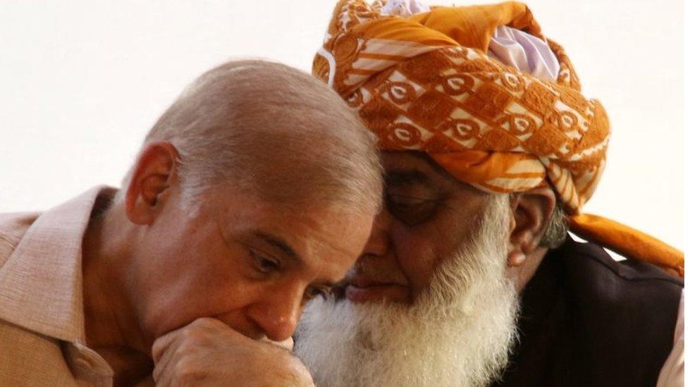 Opposition parties leaders Shahbaz Sharif (L), leader of Pakistan Muslim League Nawaz (PMLN) talks with Maulana Fazlur Rehman head of Islamic political party Jamiat Ulema-e-Islam (R) during a press conference in Islamabad, Pakistan, 30 March 2022.