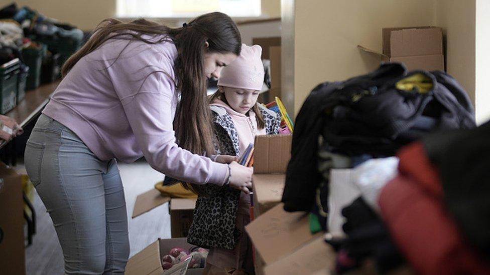 Woman and child sorting out aid