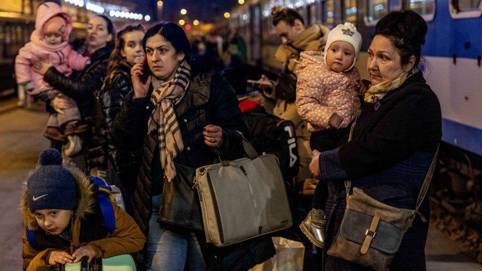 People arrive to the Western Railway Station from Zahony after crossing the border at Zahony-Csap as they flee Ukraine