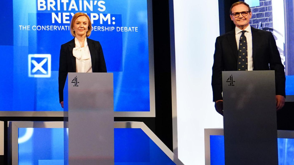 Tom Tugendhat and Liz Truss stand side by side at their podiums during a Channel 4 leadership debate