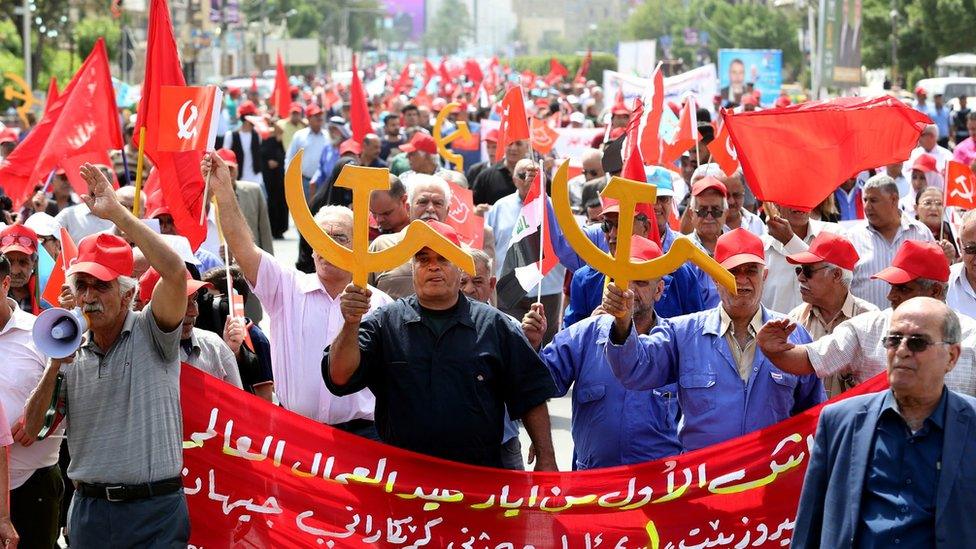 Members of the Iraqi Communist party shout slogans and carry communist flags and the communist symbols during a demonstration to mark Labour Day, in central Baghdad, Iraq, 01 May 2018.