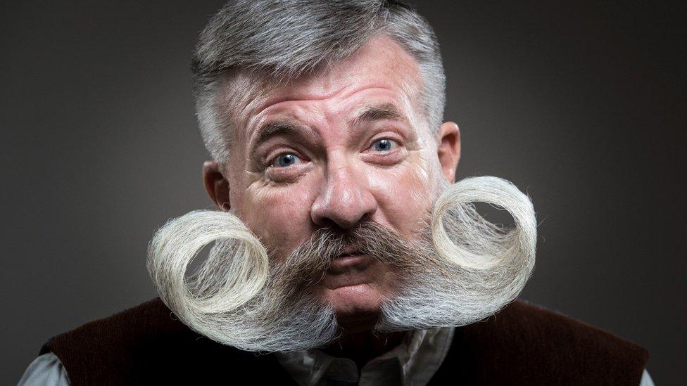 Man with curly moustache