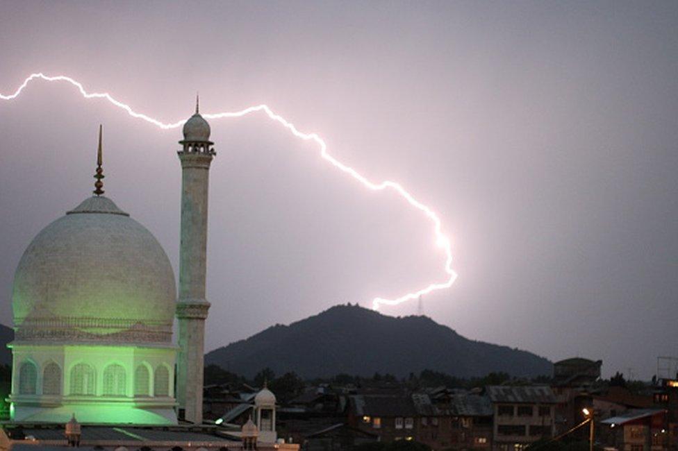 Low Angle View Of Mosque Against Lightning On Hill At Night, Srinagar