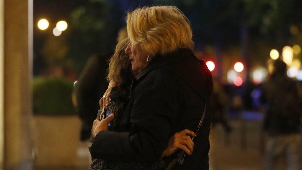 Two women hug each each other after a shooting in Paris. Photo: 20 April 2017