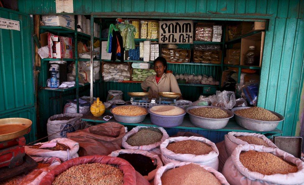 A shop owner poses for a photograph at the Mercato market in Addis Ababa December 16, 2015. Addis Ababa"s "Mercato" - Italian for "marke