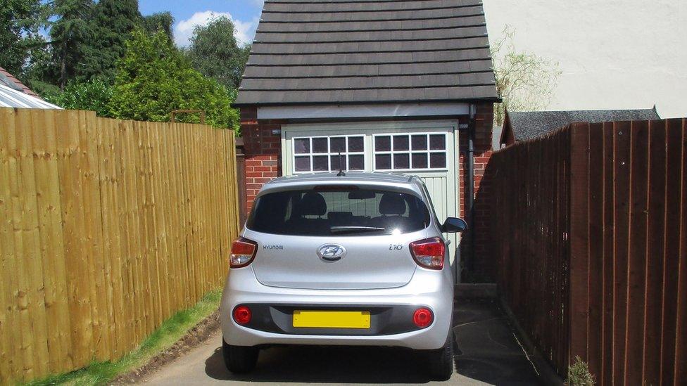 Garage with car outside