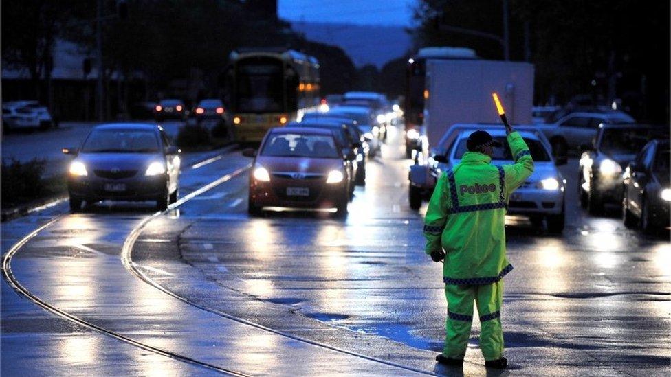 Police direct traffic in the central business district (CBD) of Adelaide after severe storms and thousands of lightning strikes knocked out power to the entire state of South Australia, September 28, 2016.