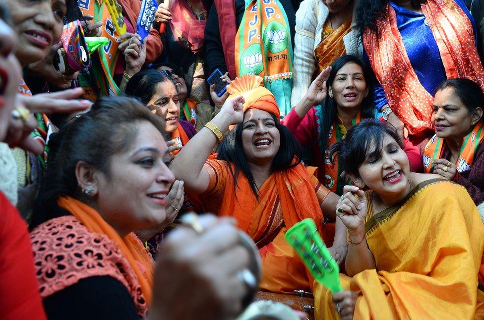 Supporters of the Bharatiya Janata Party celebrate outside the party headquarters in Delhi