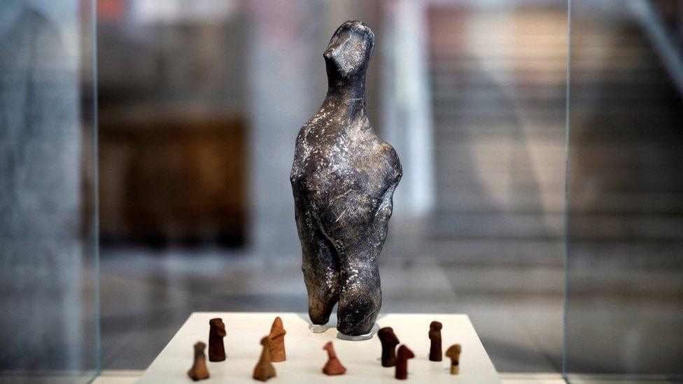 A 7,000-year-old Neolithic statuette on temporary show with bird-like clay figurines at the National Archaeological Museum in Athens, Greece, on 10 February 2017