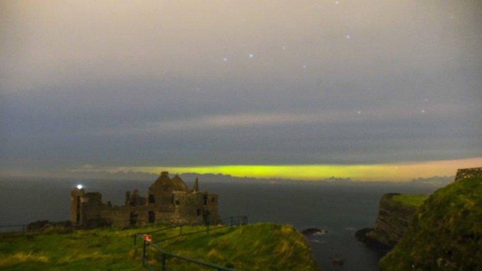 Green Northern Light captured over Dunluce Castle in County Antrim