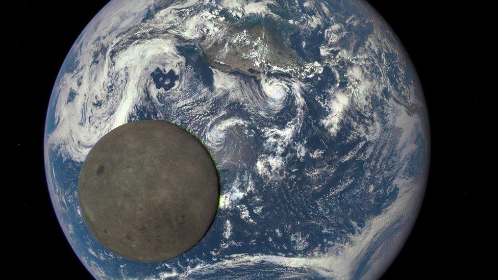 Moon orbiting the Earth.