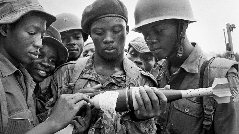 Biafran soldiers seen here inspecting a bomb during the Biafran conflict, 11th June 1968.