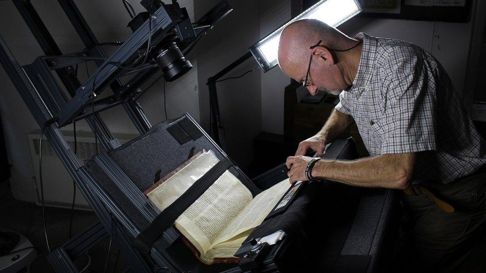 Frank Addison using the Conservation Book Cradle to digitise a manuscript from the Durham Priory Library.