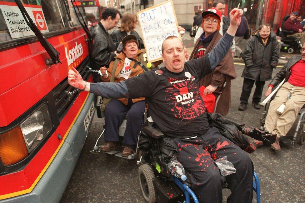 DAN protestors in front of a bus