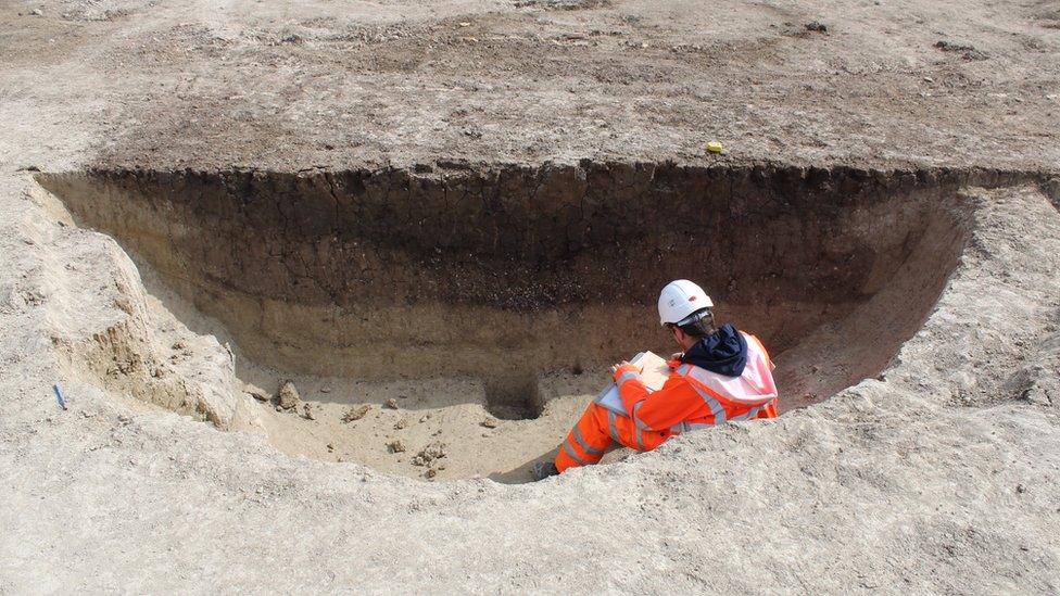 A man sitting on the edge of a pit