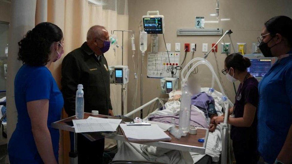 Mexico's National Migration Institute Commissioner Francisco Garduno visits a migrant injured after a fire broke out late on Monday at a migrant holding centre, in Ciudad Juarez, Mexico March 28, 2023.