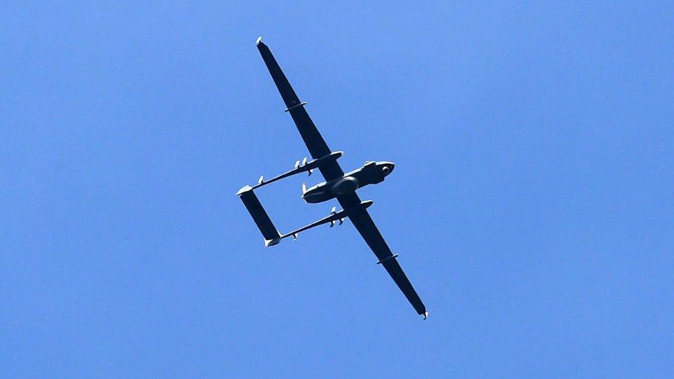 Indian army drone flies near the site of a gunbattle between Indian government forces and suspected militants in Padgampora village of Pulwama, south of Srinagar on 9 March 2017.